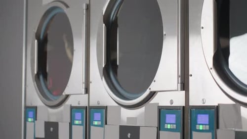 Laundry Machines in Laundromat Washing Clothes and Linens