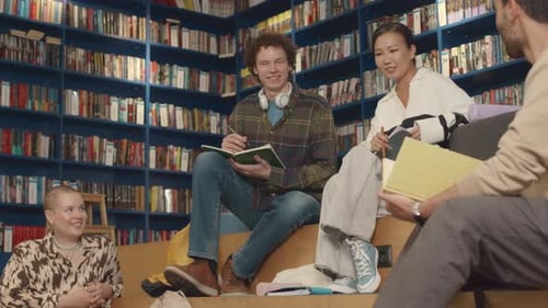 Diverse College Students Hanging Out in Library and Chatting