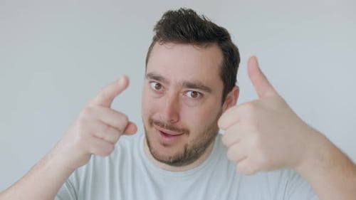 Enthusiastic Man Gives Thumbs Up and Points