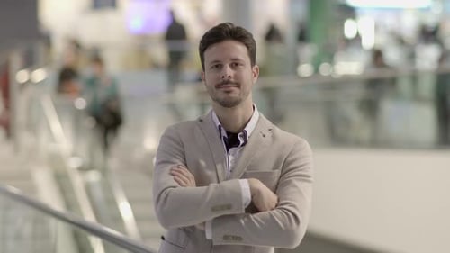 Stylish Man Confidently Poses in Urban Setting