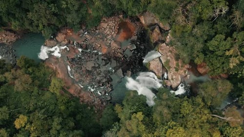 Aerial View of a Multi-Tiered Waterfall Flowing in Jungle