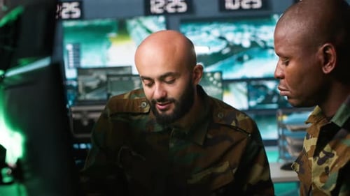 Men in Camouflage Collaborating in Control Room