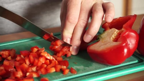 Chopping Red Pepper on a Green Cutting Board
