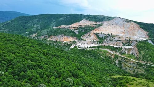 Natural Quarry is Located Near Road Against Backdrop of Rhodope Mountains and Hills with Forests and