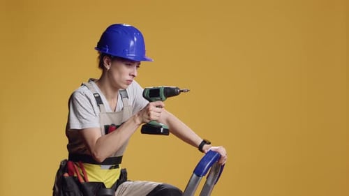 Confident Constructor Using Electric Power Drill to Screw Nails