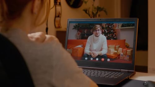Woman Video Calling with Man During Christmas Holidays