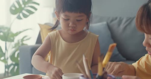 Mother and Child Painting Together at Home