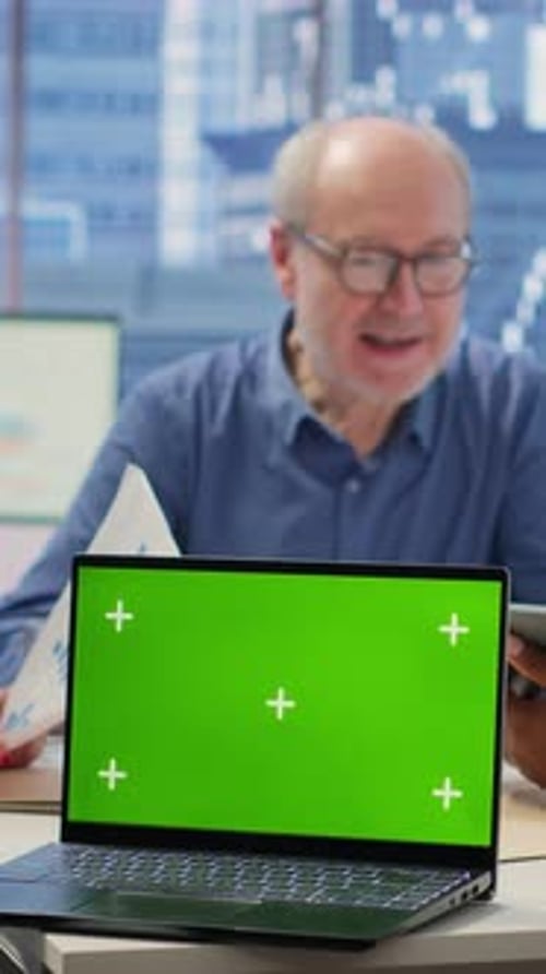 Laptop with Green Screen in Bright Modern Office