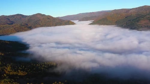 Aerial view of autumn morning fog and clouds in the valley