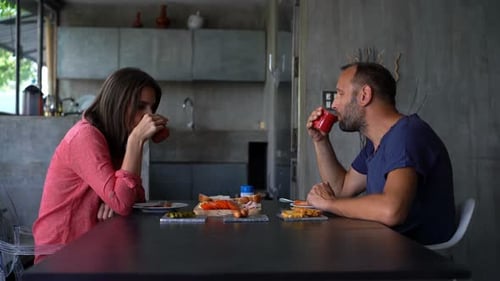 Couple enjoys morning meal together in modern kitchen
