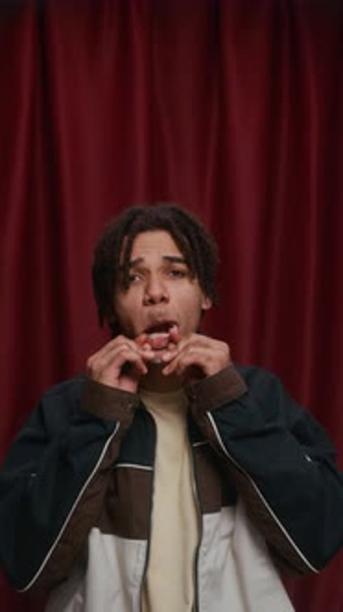 Goofy Biracial Guy with Locs Making Wild Face in Photo Booth