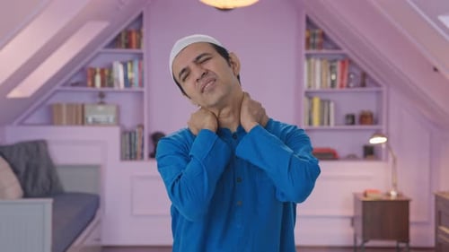 Man Experiencing Neck Pain Rubs Neck