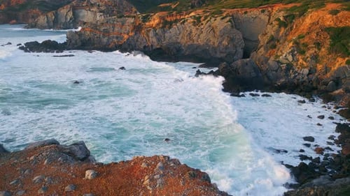 Cinematic Scenic Rocky Shore Over Stormy Foaming Ocean. Drone View Sunny Marine