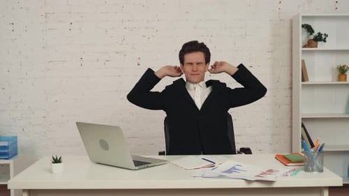 Young Adult Relaxing Then Working At Desk