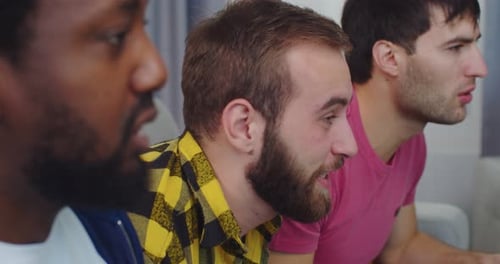 Close Up of Unhappy Guys Caucasian and African American Young Men at Home Watching Football Game on
