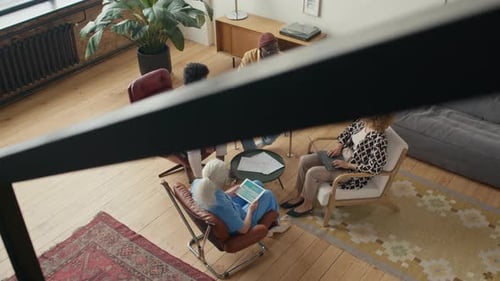 Business Team Discussing Papers on Meeting in Comfortable Office