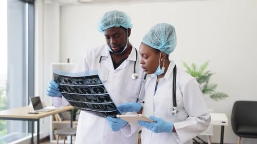 Two Medical Professionals Analyzing Xray Images in a Modern Hospital Setting