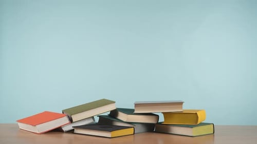 Stop Motion in Which Colorful Old Books Disappear From a Stack and Then Appear Back Forming a Pile