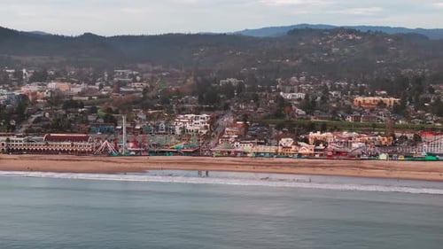 Telephoto drone shot of the beach and rides in santa cruz, California