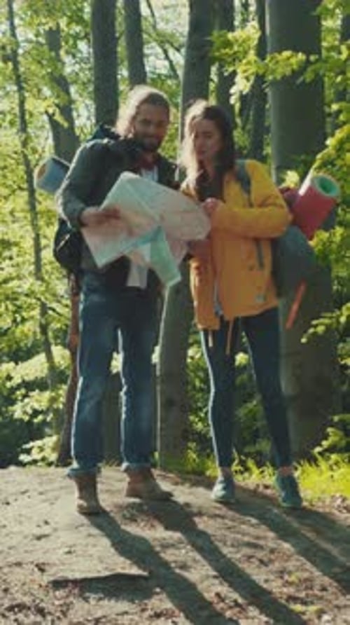 Couple Hiking Together Looking at Map in Forest