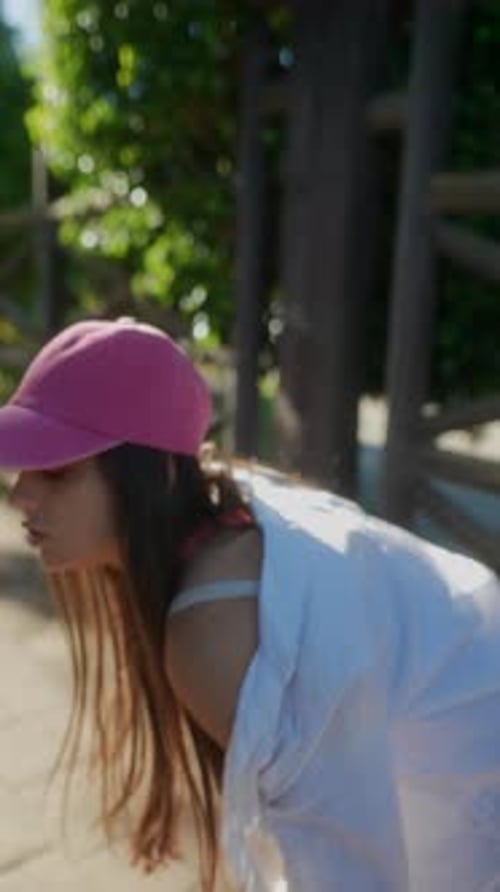 Woman Walks on Pathway in Urban Setting