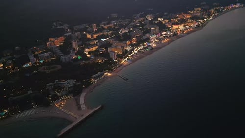 Captivating Drone View of the Bulgarian Resort's Nocturnal Coastline Twinkling Lights and Tranquil