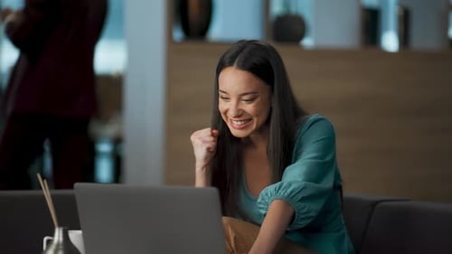 Cheerful Girl Sitting Sofa Rejoicing with Laptop