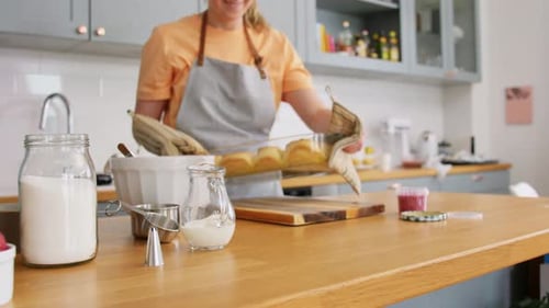 Woman Baking Cinnamon Rolls in Bright Kitchen