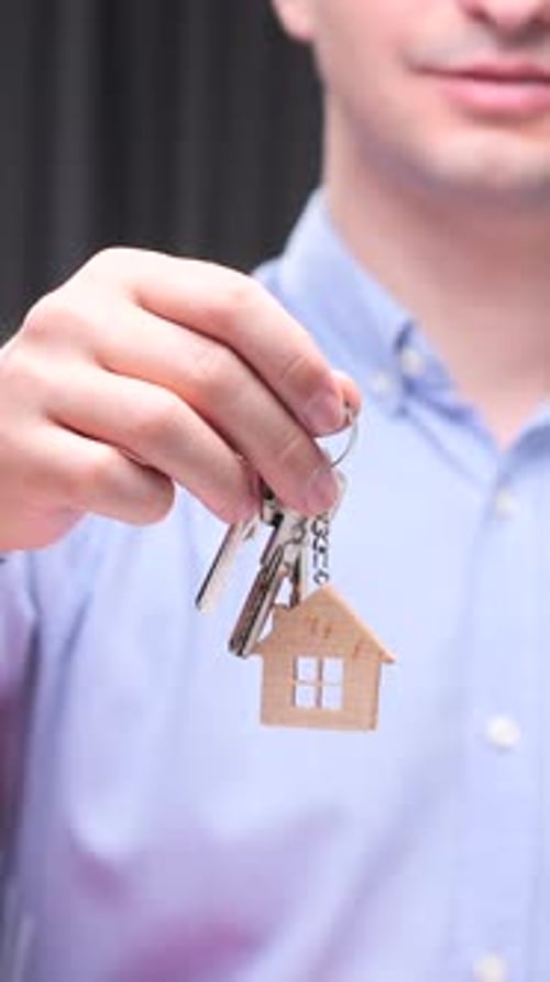 Vertical Video Real Estate Agent Holding House Keys with Keychain in Shape of House