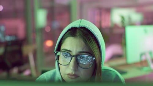 Woman with Glasses Coding at a Computer
