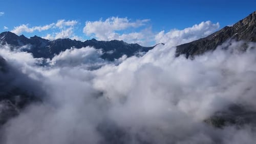 Clouds in Blue Sky Above Mountain Range in Natural Landscape