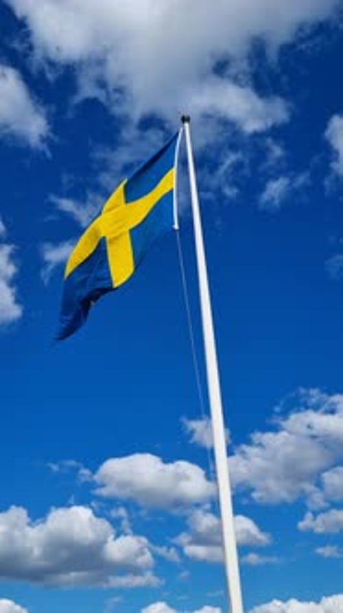 Swedish Flag Waving Proudly Against Blue Sky