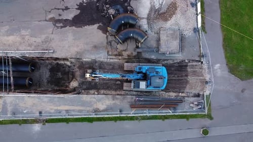 Blue Excavator Parked on Construction Site, Top, Aerial View.