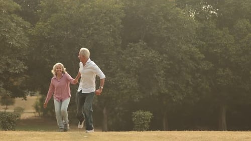 Mature Old Couple Enjoying Playful Moments in the Park