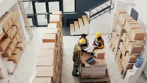 Warehouse Employees Packing Goods in Containers