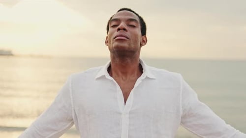 Peaceful Man Breathing Deeply on Beach at Sunset