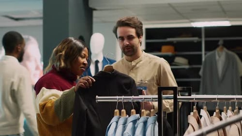 Woman Browsing Clothing with Sales Associate Assistance