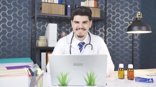 A doctor looking at the camera and smiling. In his office.