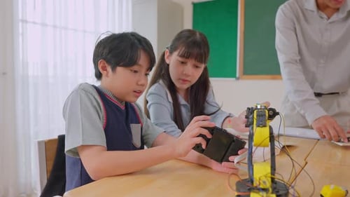 Asian students learning in a robotics class at elementary school.