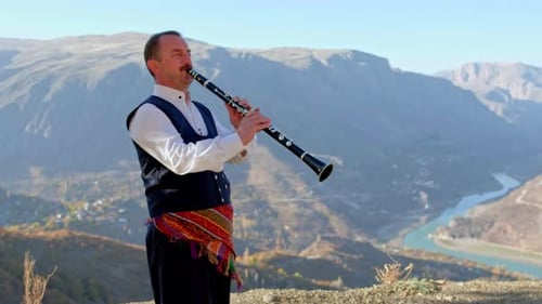 Clarinet Player by the River and Mointains