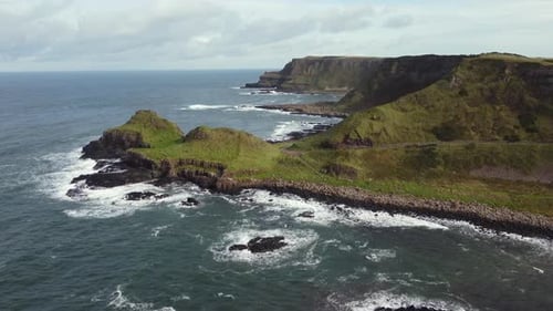 Aerial view of the Giant's Causeway on a sunny day, County Antrim, Northern Ireland. Flying towards