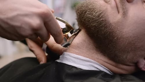 Man Receiving Beard Trim at Barbershop