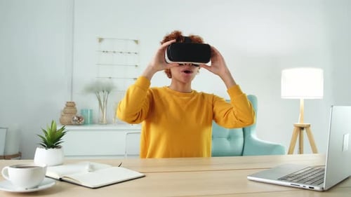 Woman at Desk Puts On VR Headset