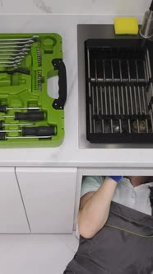 Professional Work of a Plumber Cleaning the Drain in the Sink Vertical Video