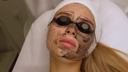 Woman with Facial Mask Treatment in Clinic