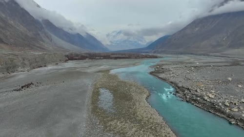 Aerial View Of Hunza River Flowing Through Nomal Valley Landscape In Gilgit. Push Forward, Tilt Up S