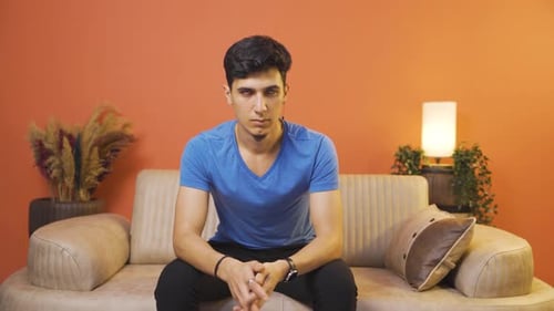 Man looking at camera with a negative expression.
