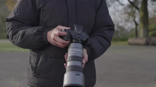 Young Man Taking Pictures in the Park