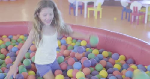 Kids Play in Colorful Ball Pit, Childlike Fun