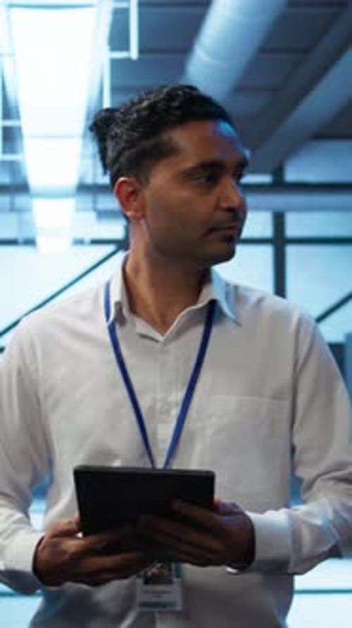 Vertical Video System Administrator Walking in Data Center Used for Managing Gear Energy